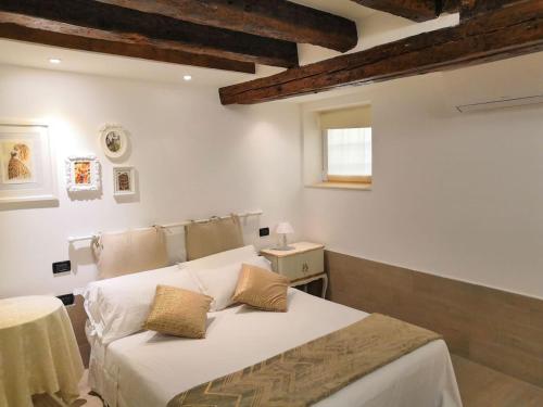 sypialnia z łóżkiem, stołem i oknem w obiekcie Appartamento AlCova w Wenecji