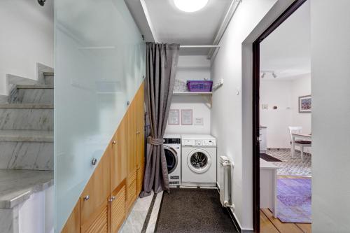 a laundry room with a washer and dryer at Apartments Viola in Zagreb