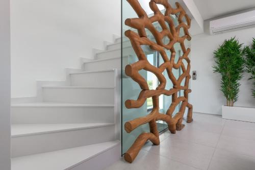 a wooden spiral staircase in a room with stairs at Albatross Beach Front Villas in Gennadi