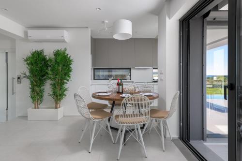 a dining room with a table and chairs at Albatross Beach Front Villas in Gennadi