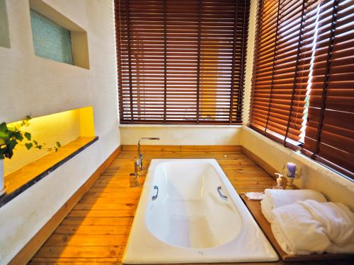 a large white bath tub in a bathroom with windows at Z.Garden in Dali