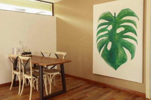 a dining room with a table and chairs and a painting at Z.Garden in Dali