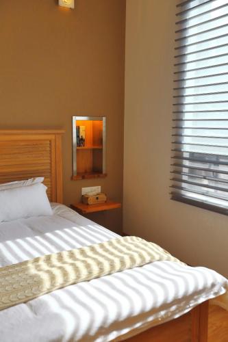 a bedroom with a bed with a mirror and a window at Z.Garden in Dali