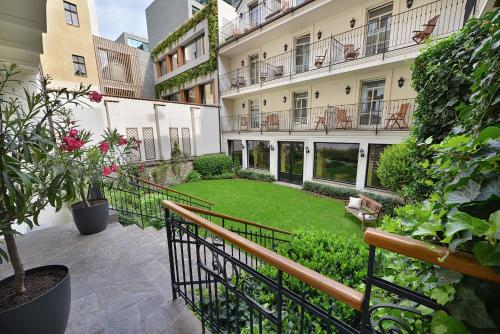 a courtyard of a building with a green yard at Angelis in Prague