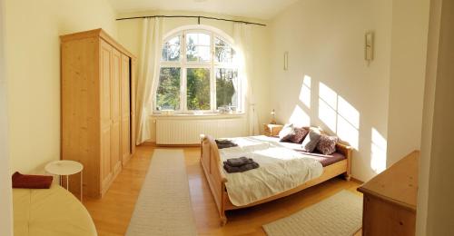 a bedroom with a bed and a large window at Ferienwohnung Schloß am Schloßberg in Bad Berka