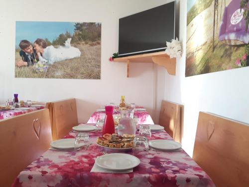 a table with a table cloth with a plate of food on it at Agriturismo Prato degli Angeli in Sassoleone