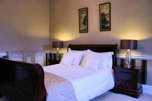 a bedroom with a large bed with white sheets and pillows at Rathaspeck Manor B&B in Wexford