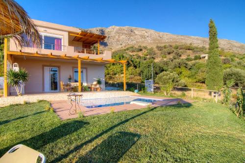 a house with a swimming pool in a yard at Villa Despina 2 Plakias Private Villa, Private Swimming Pool Garden, Panoramic Sunset in Asómatoi