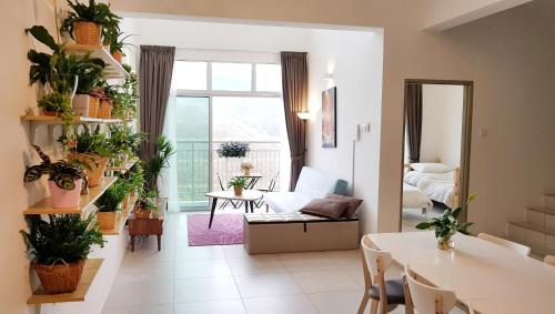 a living room filled with lots of plants at Penthouse - Secret Garden de Cameron, Night Market in Tanah Rata