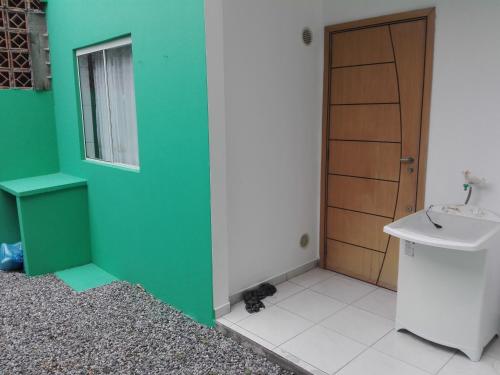 a bathroom with a cat sitting next to a sink at Casa de Praia in Itapema