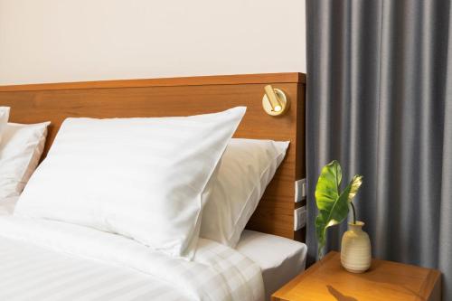 Una cama o camas en una habitación de Sukhon Hotel - SHA Plus
