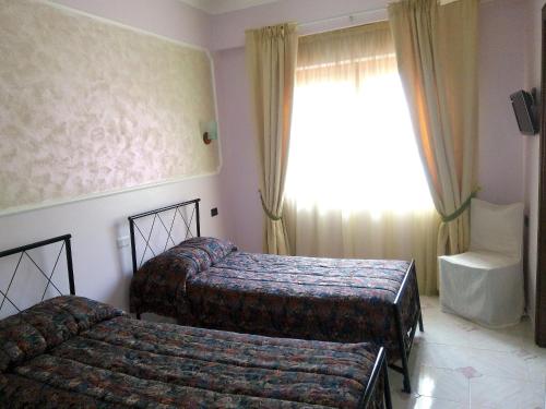 Postel nebo postele na pokoji v ubytování HOTEL AL QUERCETO