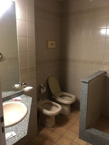 a bathroom with a toilet and a sink at Hotel Rey in Buenos Aires