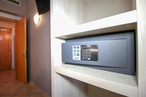 a television on a shelf in a wall at Hotel Miramonti in Turin