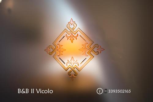 a lit up candle on a blurry background at Il Vicolo - Affittacamere in Ruvo di Puglia