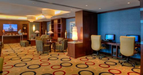 a hotel room with a salon with chairs and a table at Oceanic Khorfakkan Resort & Spa in Khor Fakkan