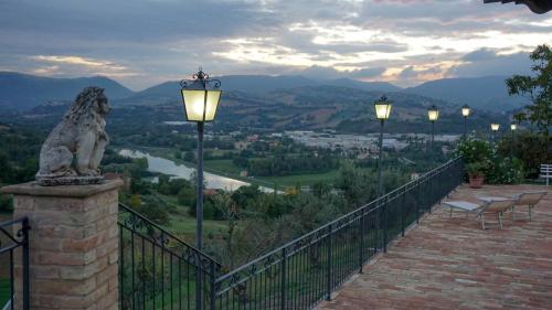 a statue of a lion sitting on a fence with lights at Agriturismo Pascucci in Tolentino