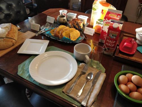 a wooden table topped with plates of food at Maurrocks - A Pocono Mountains B&B in Mount Pocono