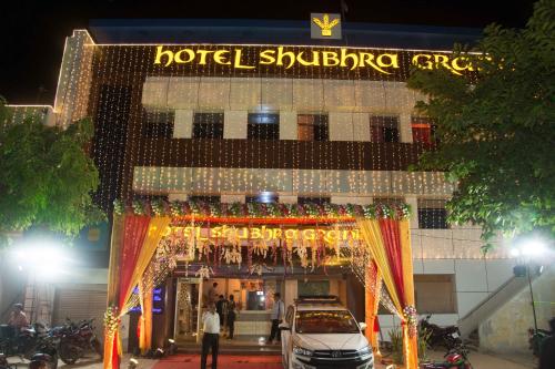 a hotel with a sign on the front of it at Hotel Shubhra Grand in Ghāzīpur