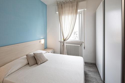 מיטה או מיטות בחדר ב-Residence Rimini Mare