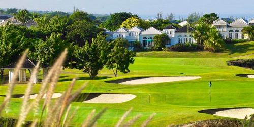 a view of a golf course with houses at Royal Westmoreland Benjoli Breeze, Palm Ridge 10 by Island Villas in Saint James