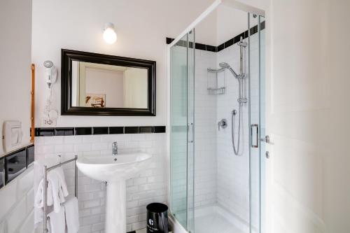 a bathroom with a sink and a shower at Culture Residence Consalvo Otto in Naples