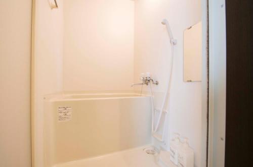 a white bathroom with a shower and a tub at Sannand / Vacation STAY 2187 in Sapporo