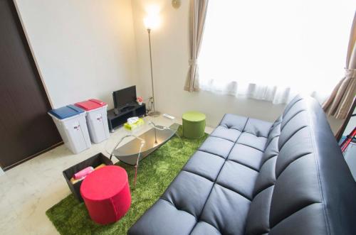 uma sala de estar com um sofá azul e uma mesa em Sannand / Vacation STAY 2187 em Sapporo