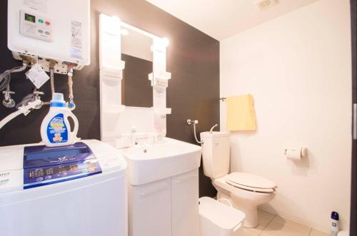a white bathroom with a sink and a toilet at Sannand / Vacation STAY 2187 in Sapporo