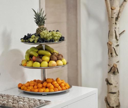 two tiers of fruit on display on a shelf at Aparthotel Centar Sarajevo in Sarajevo