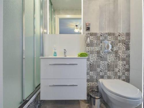 a bathroom with a white sink and a toilet at Zacisze pod Halami in Szlachtowa