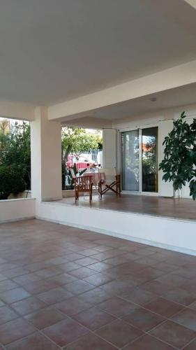 an empty patio with a table in the middle at NN Luxury Room near Athens Airport in Spáta