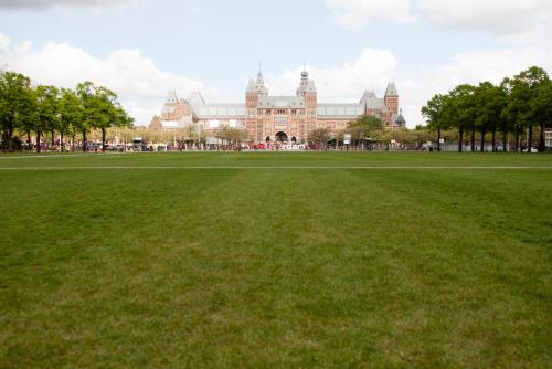 a large field of grass in front of a building at Budget Trianon Hotel in Amsterdam
