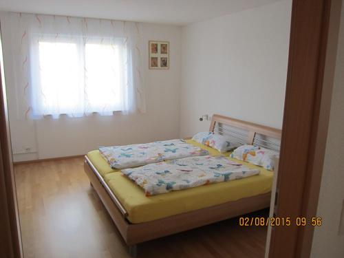 a bedroom with a bed and a window at Mühlgarten in Immenstaad am Bodensee