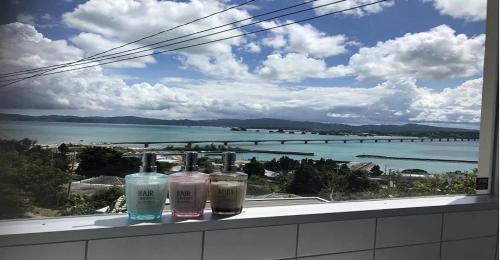 a window with three glass bottles on a ledge at 220 Kouri Nakijin-son - Hotel / Vacation STAY 8715 in Nakijin