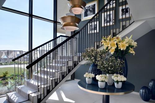 a staircase with flowers in vases on a table at Al Alamein Hotel in El Alamein