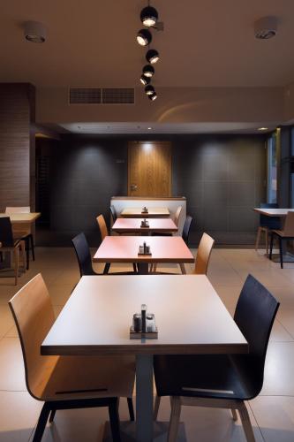 a row of tables and chairs in a restaurant at Fekete Sas Motel in Esztergom