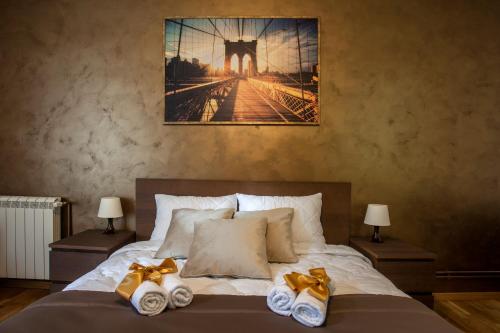 a bedroom with a bed with two towels on it at Knez Mihailova Apartman in Belgrade