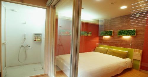 a bedroom with a shower and a bed and a tub at 41-2 Surugamachi - Hotel / Vacation STAY 8328 in Nara