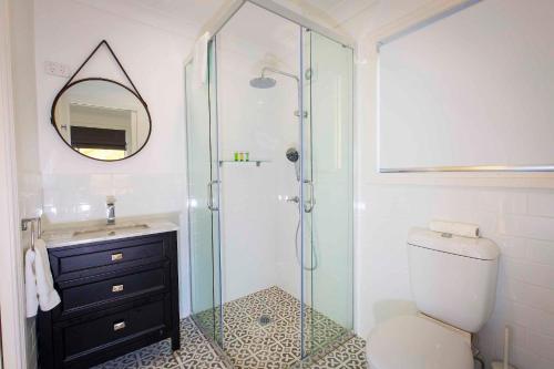 a bathroom with a shower and a toilet and a sink at Montana in Mount View