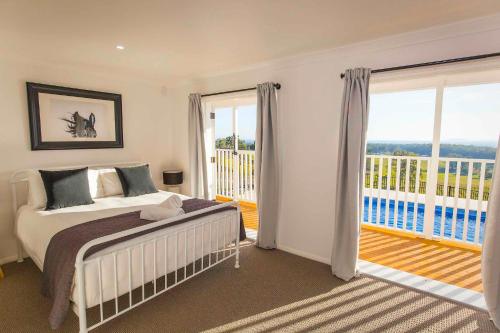 a bedroom with a bed and a balcony at Montana in Mount View