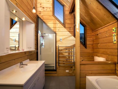a bathroom with two sinks and a shower and a mirror at mulberry house in Picton