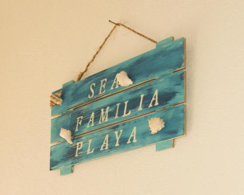 a blue sign hanging on a wall at Bungalows Las Hamacas in San Patricio Melaque