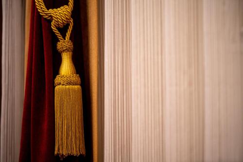 a close up of a curtain with a tie at Boutique Hotel Golden Star in Tuzla
