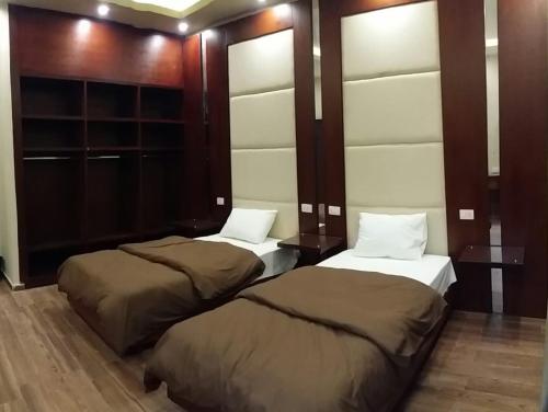 Postel nebo postele na pokoji v ubytování Grand Palace Hotel