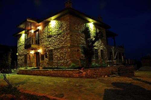 a stone house with lights on it at night at Beymelek Tas Evler in Demre