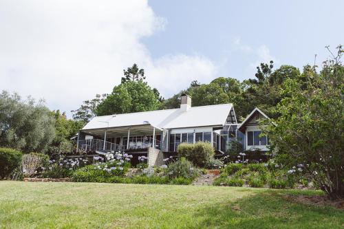 a house with a garden in front of it at The Retreat Tamborine Mountain in Mount Tamborine