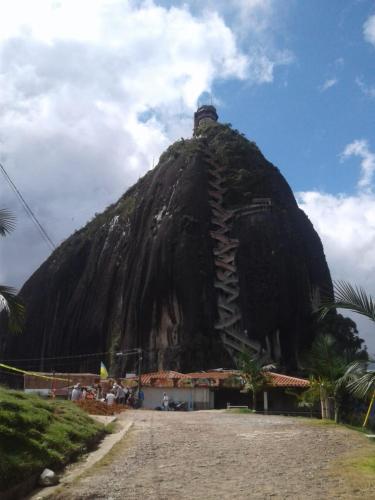 a mountain with a building on top of it at Balcones de la Casona in Guatapé