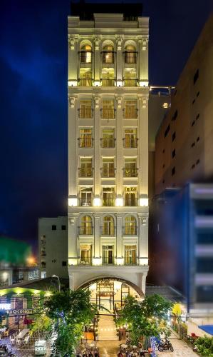 a tall white building with a lit up facade at Le House Boutique Hotel - 100m to the beach in Da Nang