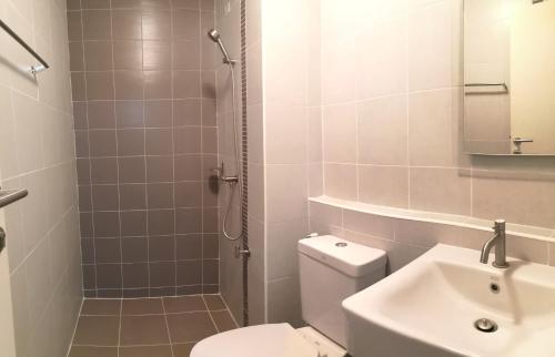 a bathroom with a toilet and a sink and a shower at D Condo Nernpra Rayong in Rayong